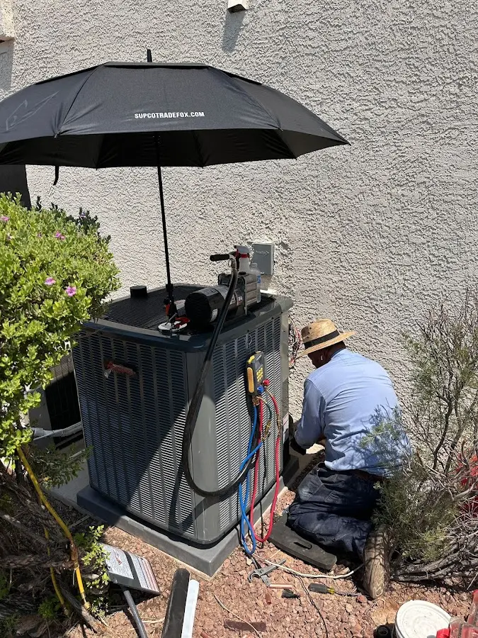 HVAC technician performing outdoor AC maintenance in North Codorus